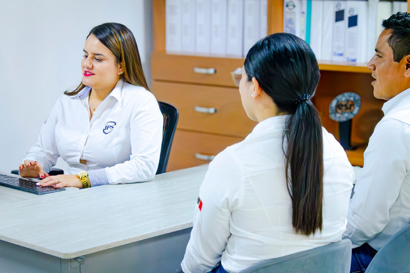 Grupo IPS colleagues working together at an office desk