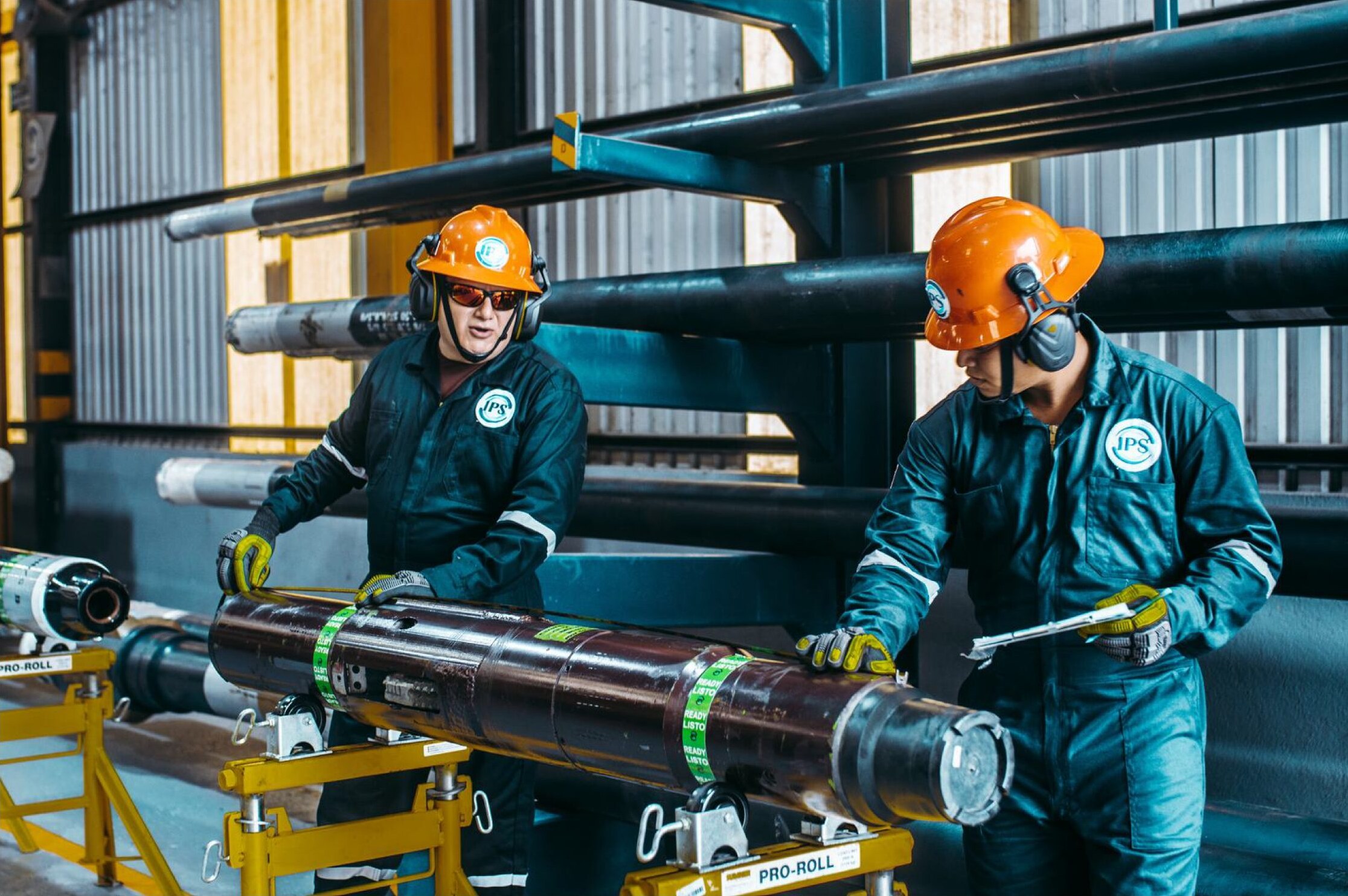 Two technicians assembling a liner hanger on a stand