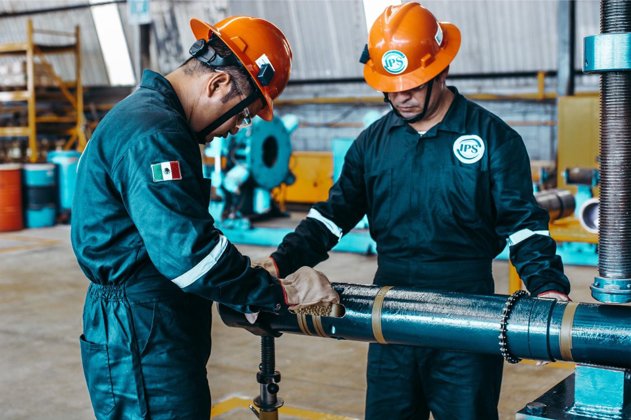 Two technicians fitting a liner hanger component