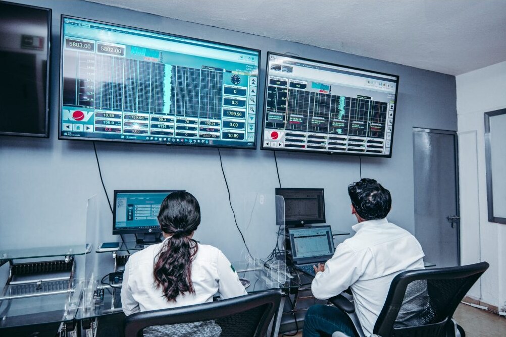 Engineers monitoring downhole data in a control room