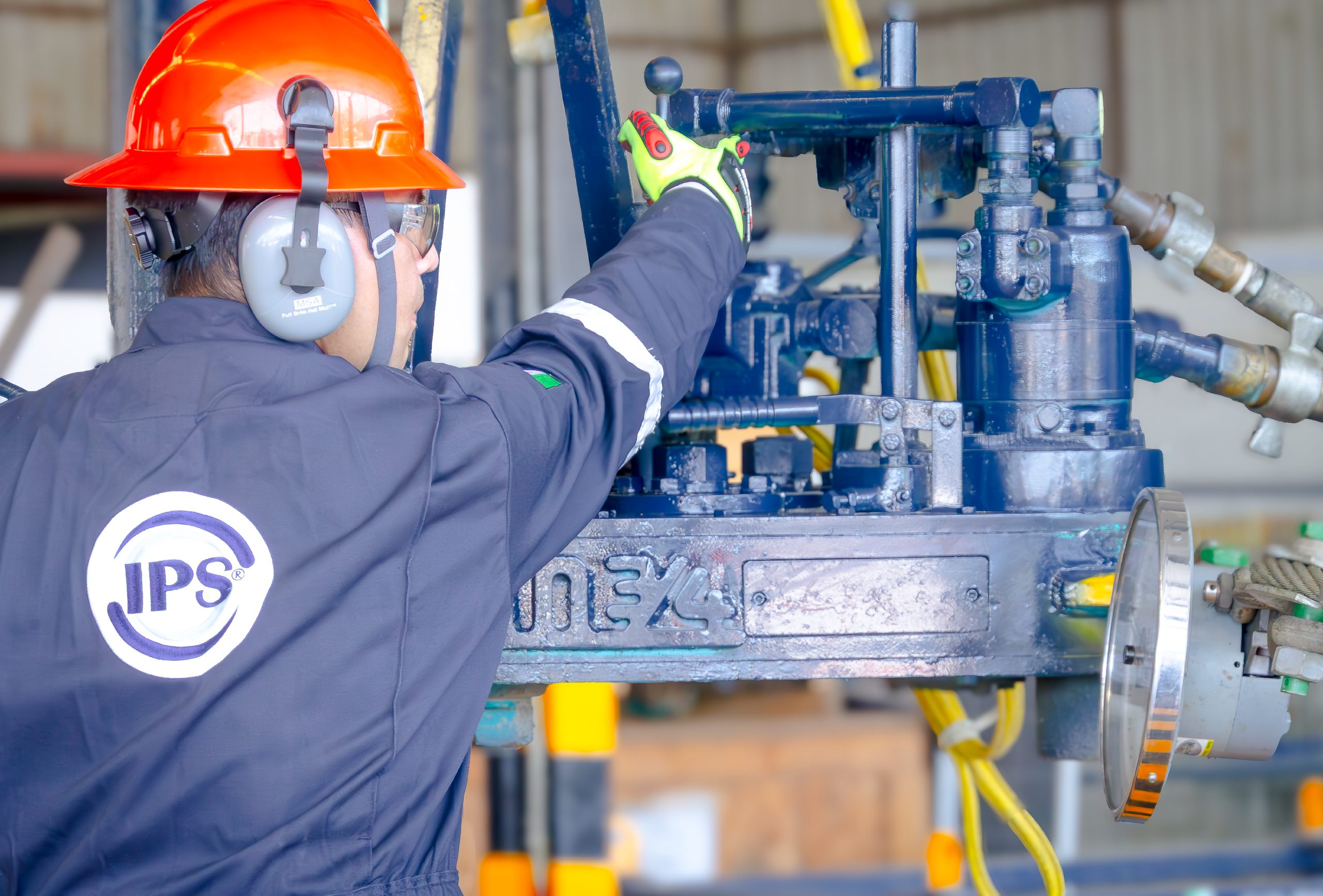 Technician operating tubular running equipment