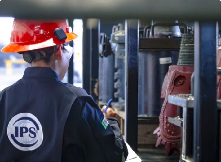 Technician inspecting tricone bits in the workshop