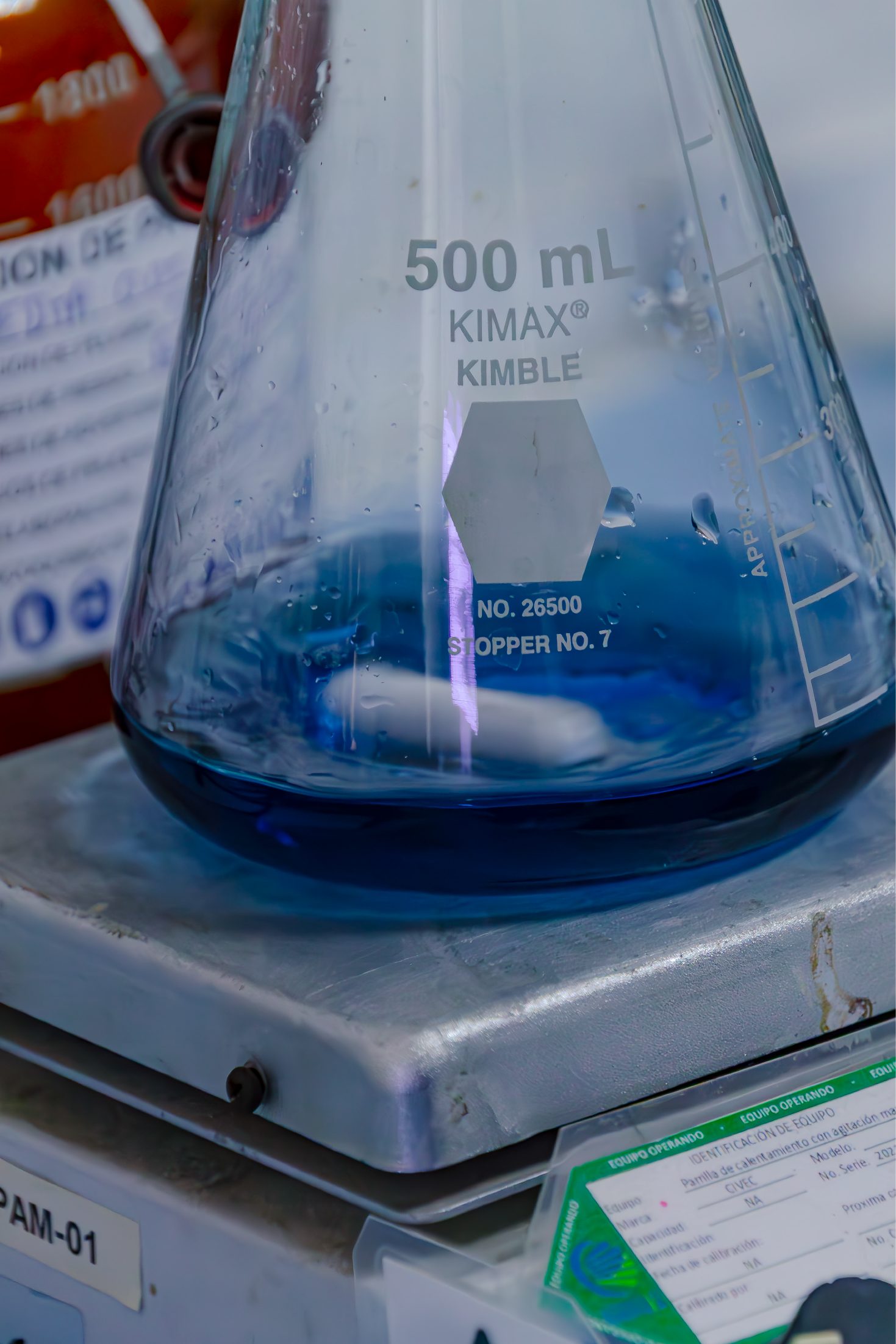 Laboratory flask with a blue solution on a stirring plate